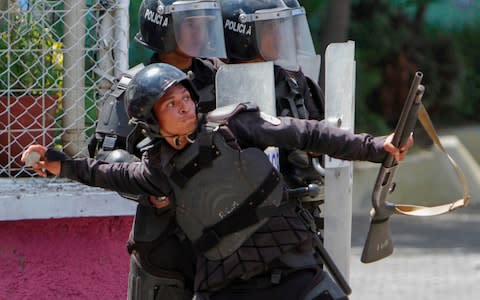 Armed police have been accused of using excessive force crushing protests, while security service torture protesters - Credit: INTI OCON/AFP