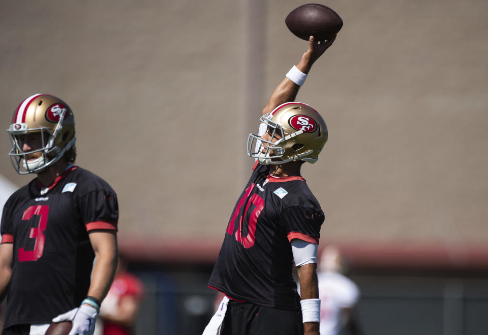 San Francisco 49ers quarterback Jimmy Garoppolo (10) reaches up to catch a ball before running a drill during NFL Training Camp practice Saturday, Aug. 15, 2020, at the SAP Performance Facility in Santa Clara, Calif. (Xavier Mascarenas/The Sacramento Bee via AP)