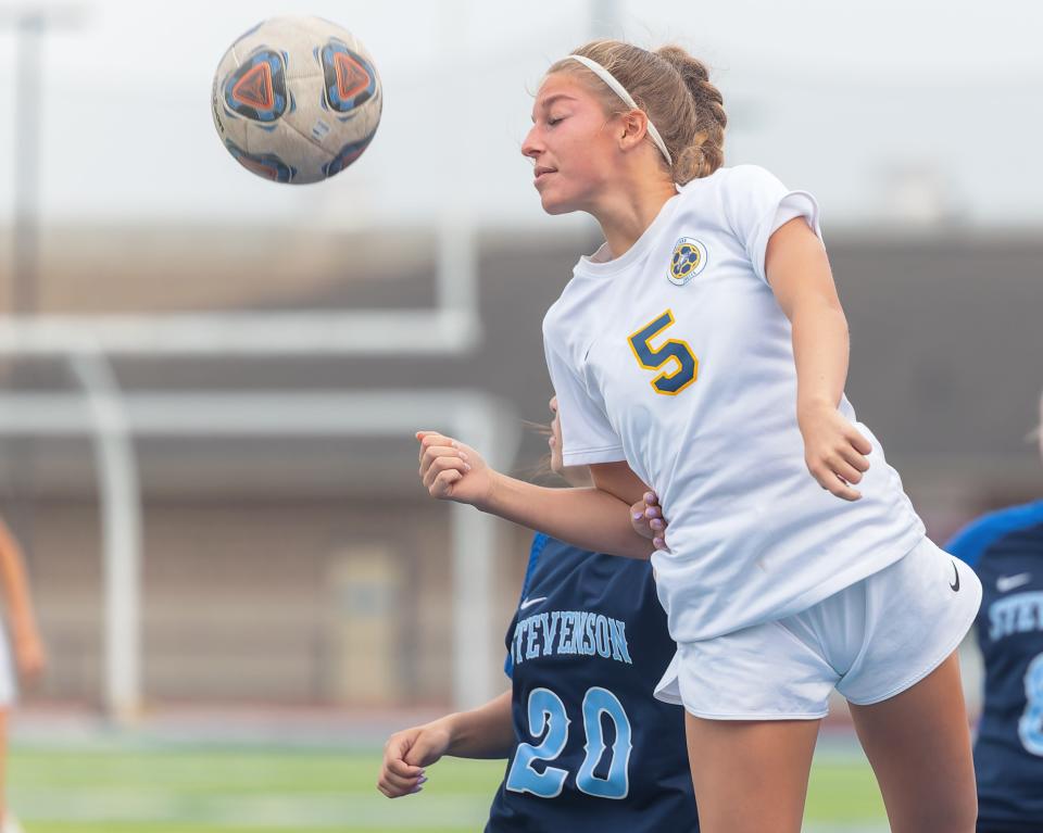 Hartland's Josie Cheyne heads the ball front of Livonia Stevenson's Olivia Mattson during the KLAA championship soccer game Thursday, May 16, 2024.