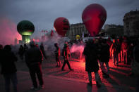 Demonstrators march during a demonstration against plans to push back France's retirement age, Tuesday, Jan. 31, 2023 in Paris. Labor unions aimed to mobilize more than 1 million demonstrators in what one veteran left-wing leader described as a "citizens' insurrection." The nationwide strikes and protests were a crucial test both for President Emmanuel Macron's government and its opponents. (AP Photo/Christophe Ena)