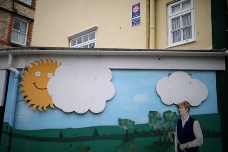 A mural showing a farmer walking beneath a cloudy sky is seen in Ilfracombe