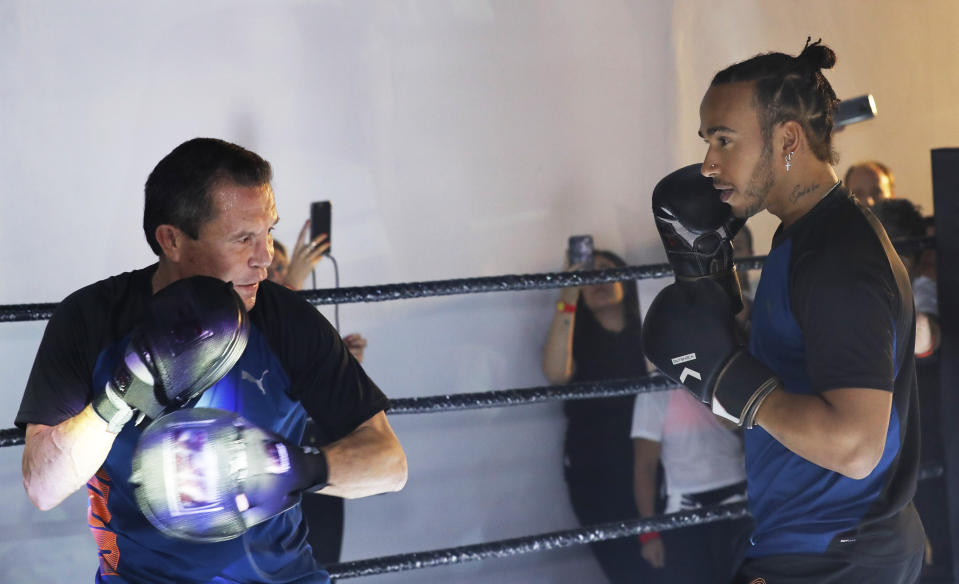 Mexican former boxing champion Julio Cesar Chavez, left, and British Mercedes driver Lewis Hamilton, spar during a promotional event ahead of the Formula One race in Mexico City, Wednesday, Oct. 23, 2019. Mexico Formula One Grand Prix will take place on Sunday, Oct. 27. (AP Photo/Marco Ugarte)