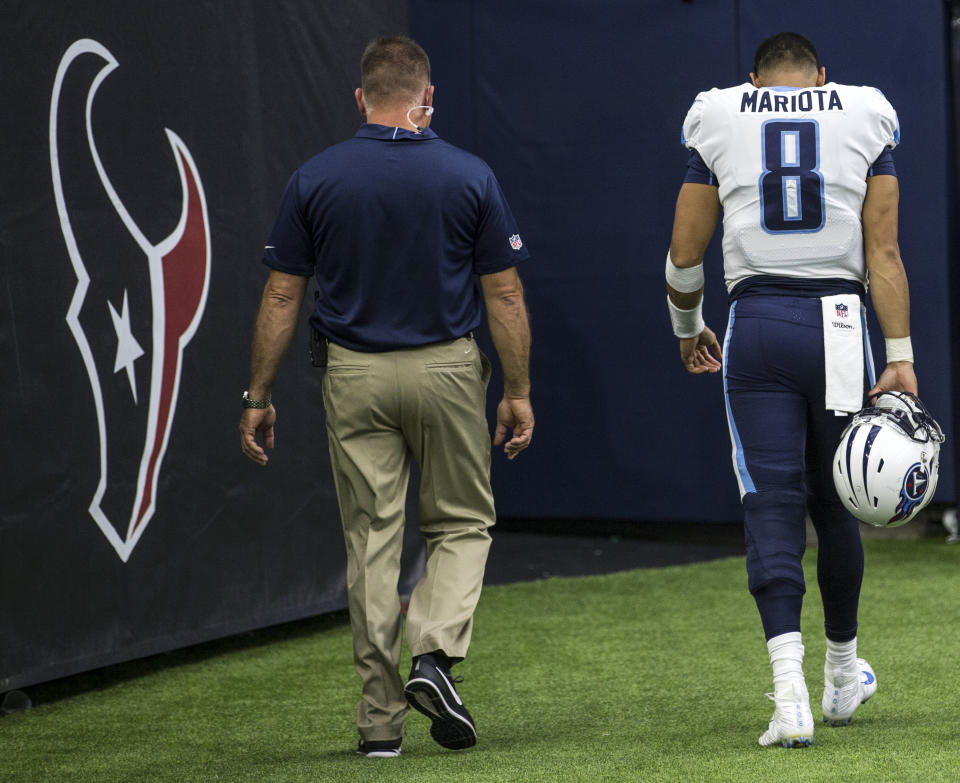 Titans quarterback Marcus Mariota walks off the field after suffering a hamstring injury against the Texans on Sunday. (AP)