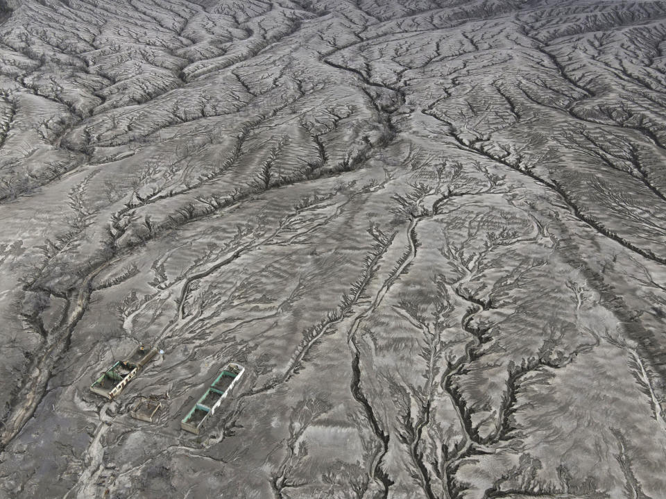 The remains of the Alas-as elementary school are seen in the middle of patterns of erosion on volcanic ash deposits at the Taal volcano almost a year after it erupted, on Sunday, Jan. 10, 2021 in Batangas province, Philippines. A popular tourist destination just south of Manila because of its picturesque setting in the middle of a lake, Taal erupted on Jan. 12, 2020. The eruption displaced thousands of villagers living near the area and delivered an early crisis this year for one of the world's most disaster-prone nations a couple of months before the COVID-19 pandemic broke in the country. (AP Photo/Aaron Favila)