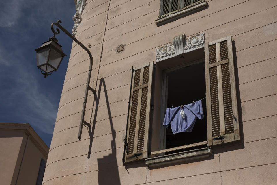 A mask dries in the sun together with a pair of pants in Cannes, southern France, Tuesday, May 12, 2020. The Cannes Film Festival won't kick off as planned on Tuesday. The festival's 73rd edition has been postponed indefinitely, part of the worldwide shutdowns meant to stop the spread of the coronavirus. (AP Photo/Daniel Cole)