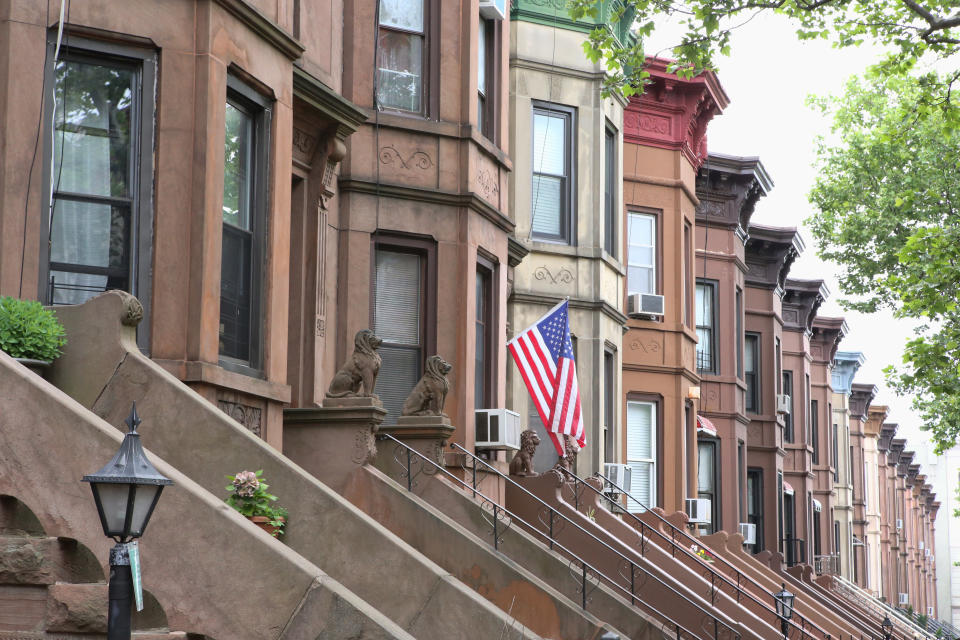 American flag hanging from the front door of a brownstone in a typical middle-class residential neighborhood in Brooklyn, New York City.