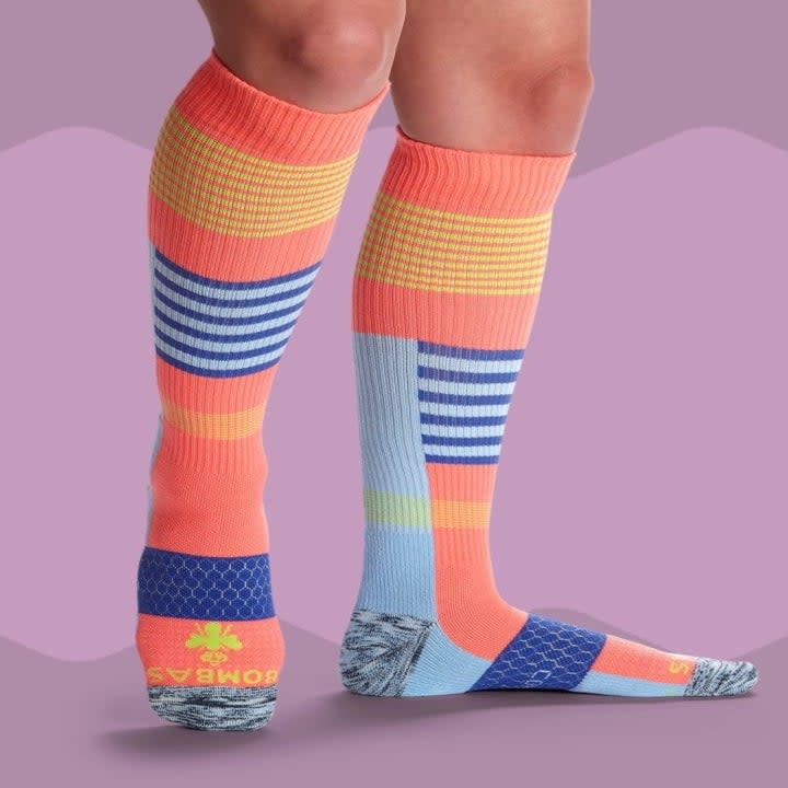 model in color-blocked knee-high compression socks