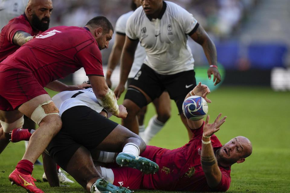 Georgia's Nodar Cheishvili passes the ball during the Rugby World Cup Pool C match between Fiji and Georgia at the Stade de Bordeaux in Bordeaux, France, Saturday, Sept. 30, 2023. (AP Photo/Thibault Camus)