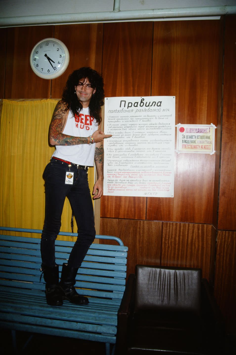 <p>Tommy Lee, Mötley Crüe's founding member and drummer, poses with a Soviet Union poster written in Russian, while backstage before a performance in the USSR's Moscow. The musician was married to actress Heather Locklear at the time. </p>