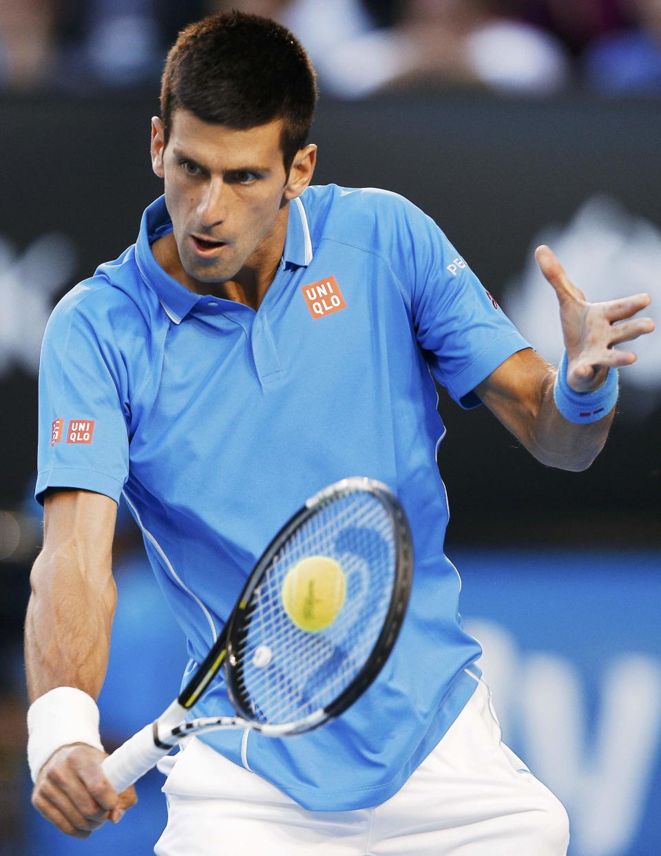 Novak Djokovic of Serbia hits a return against Milos Raonic of Canada during their men's singles quarter-final match at the Australian Open 2015 tennis tournament in Melbourne January 28, 2015. REUTERS/Athit Perawongmetha (AUSTRALIA - Tags: SPORT TENNIS)