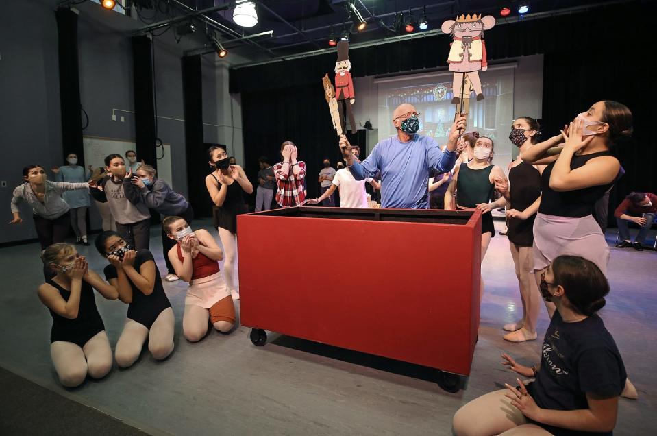 Marc Ozanich, playing the part of Drosselmeyer, practices a scene with dancers from the Dance Institute of the University of Akron during a rehearsal for "The Akron Nutcracker" on Sunday at Guzzetta Hall.