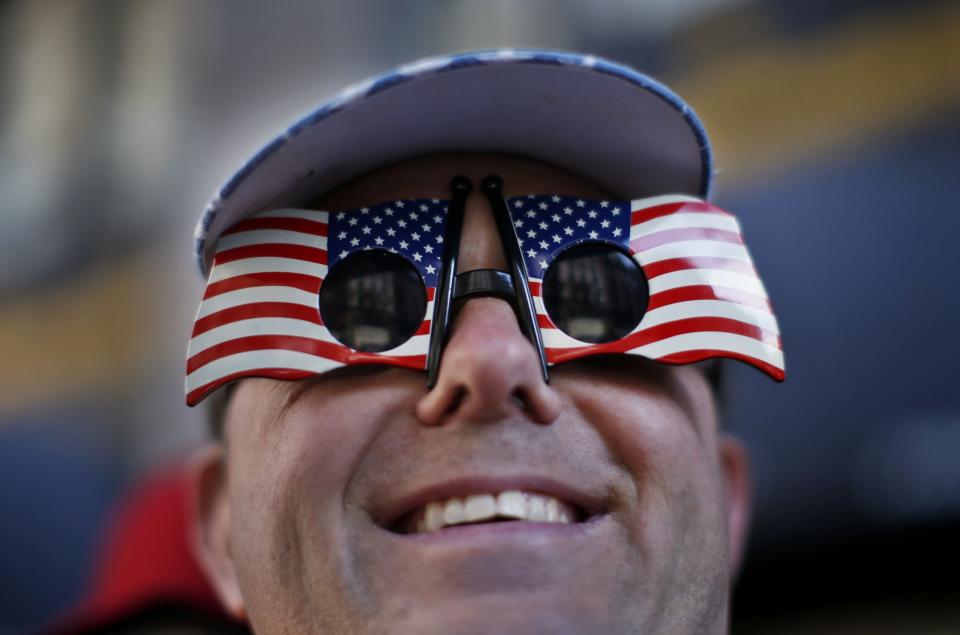 Turner from Brooklyn, New York wears American flag glasses as he watches the New York City Veterans Day parade on 5th Avenue in New York