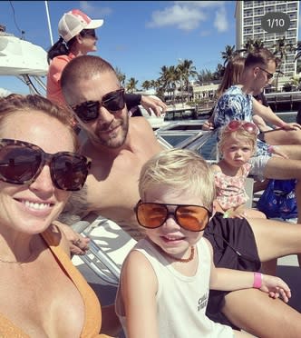 Mina Starsiak Hawk sits in beach chairs with her family