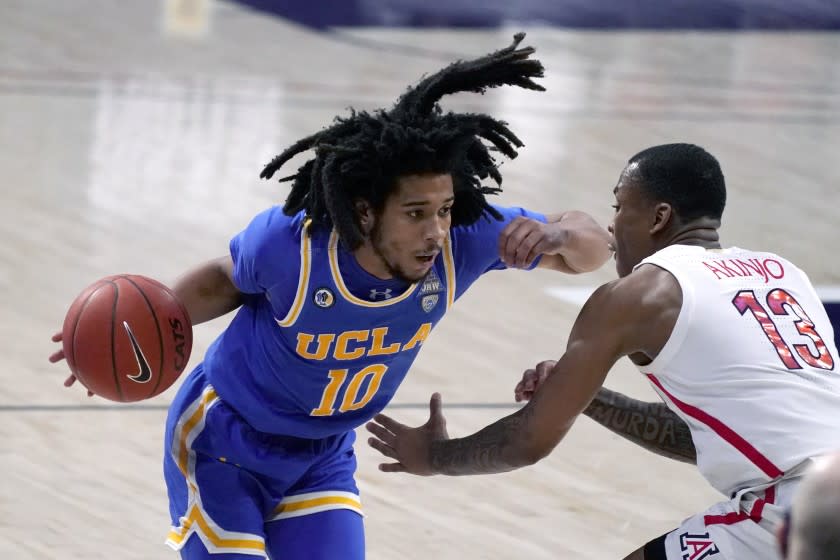 UCLA guard Tyger Campbell (10) drives on Arizona guard James Akinjo during the second half.