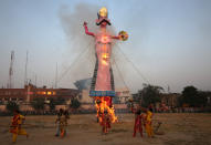 <p>Artists dressed as Hindu gods react as an effigy of Kumbhkarana, brother of demon king Ravana, burns during Vijaya Dashmi or Dussehra festival celebrations in Jammu, India, Sept. 30, 2017. (Photo: Mukesh Gupta/Reuters) </p>