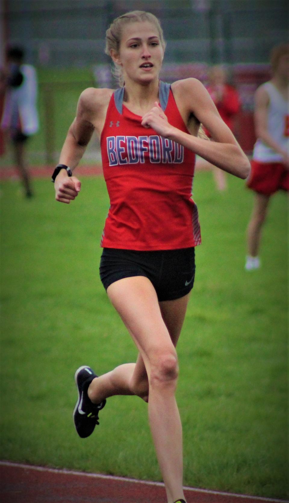 Bedford's Ally Betkey crosses the finish line in first place during the 400-meter run last year at Monroe High School.