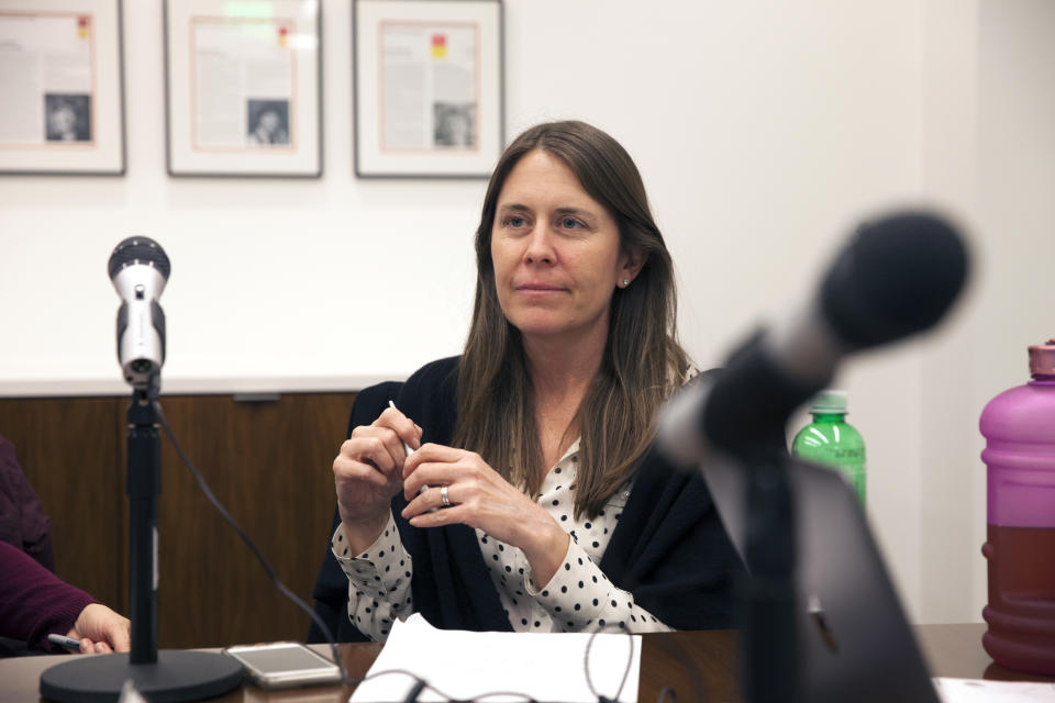 Republican strategist Liesl Hickey, sitting next to a microphone, prepares to record an episode of her podcast. 