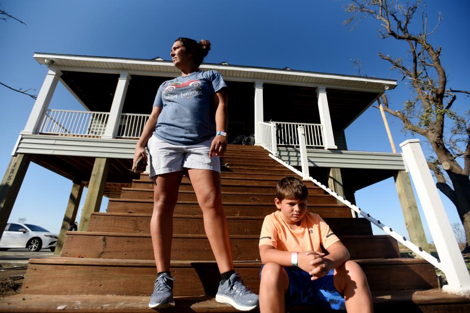 Edie Higgins and her oldest son, Eli Higgins, in front of their house the day after Hurricane Delta in Cameron, Louisiana, on Saturday, Oct. 10, 2020.