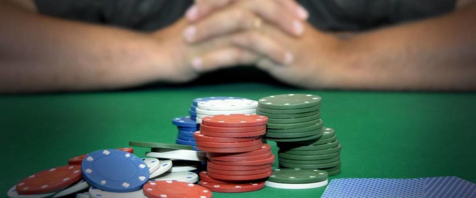 Stressed man in a poker table gambling