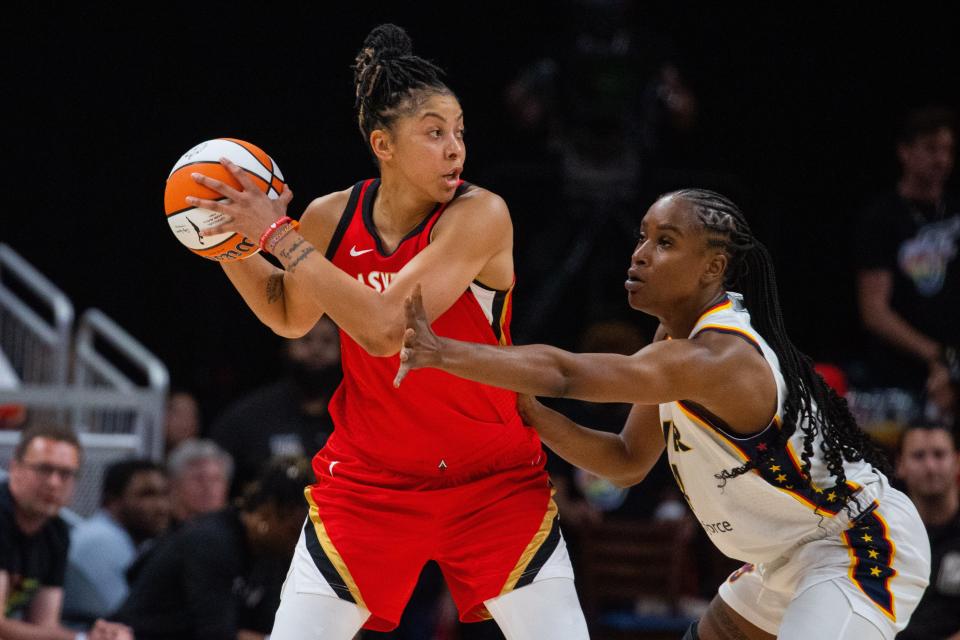 Aces forward Candace Parker (3) looks to pass the ball while Fever center Queen Egbo (4) defends.