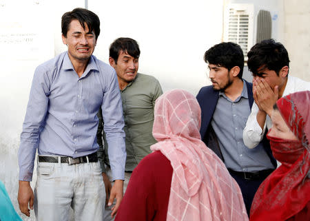 Afghan men mourn after a blast in a hospital in Kabul, Afghanistan August 15, 2018. REUTERS/Mohammad Ismail