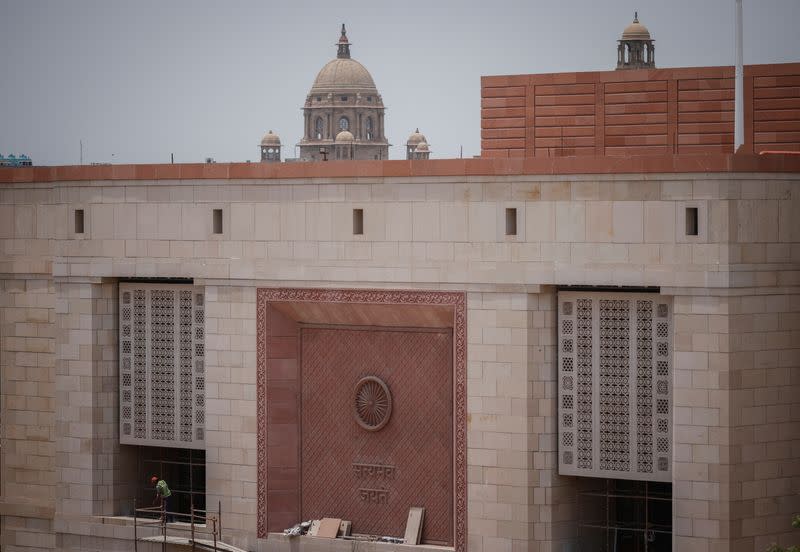 A labourer works at the under construction site of the new parliament building in New Delhi