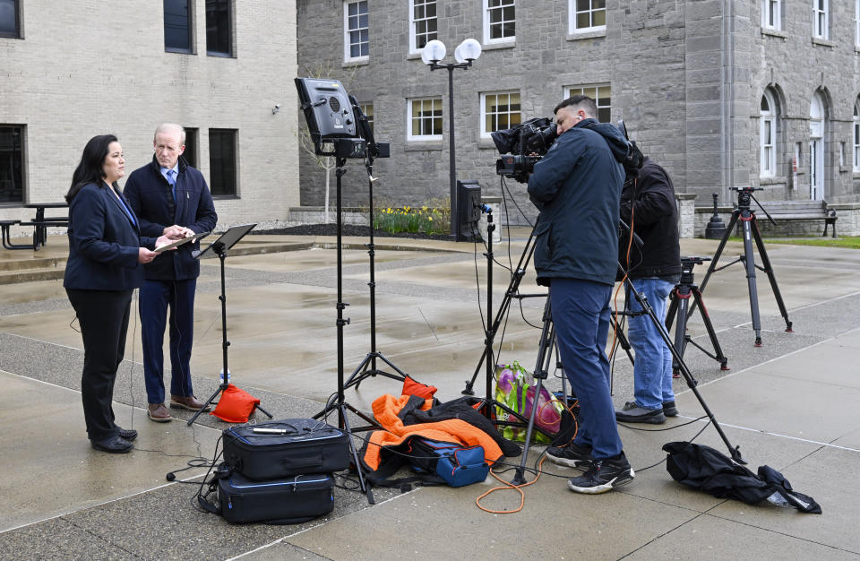 Television reporters produce news reports during Nauman Hussain's new trial in Schoharie, N.Y., on Monday, May 1, 2023. Judge Peter Lynch, rejected a plea agreement for Hussain, who ran the limousine company involved in the 2018 crash that killed 20 people, to avoid prison time. (AP Photo/Hans Pennink)