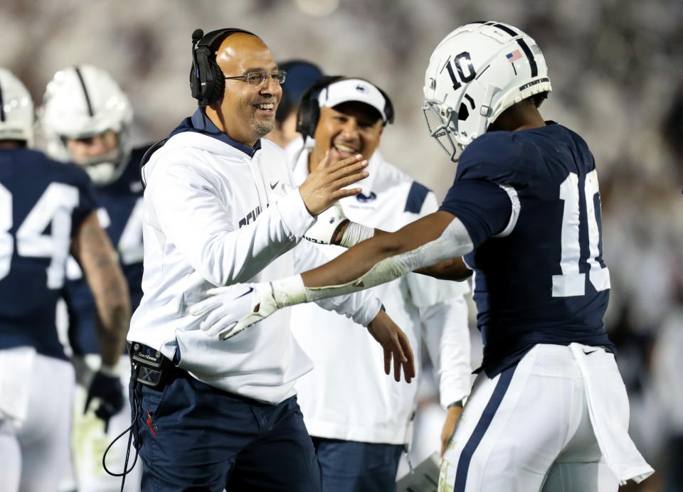 Oct. 22, 2022; University Park, Pennsylvania; Penn State Nittany Lions head coach James Franklin celebrates with running back Nicholas Singleton (10) after scoring a touchdown during the third quarter against the Minnesota Golden Gophers at Beaver Stadium. Penn State defeated Minnesota 45-17. Matthew O’Haren-USA TODAY Sports