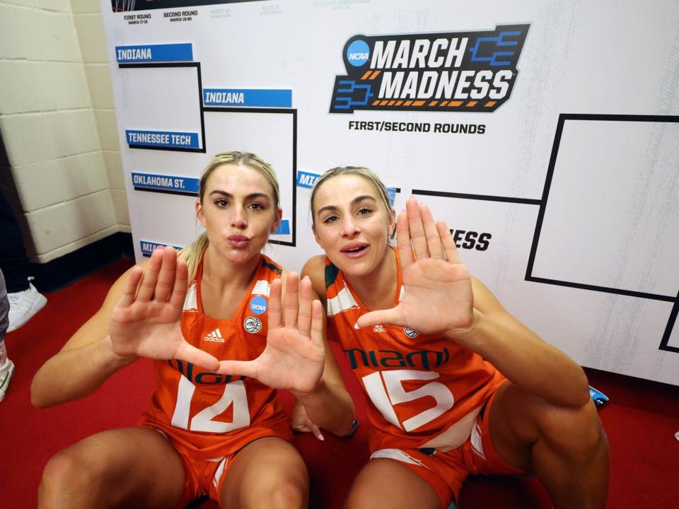 Haley Cavinder and Hanna Cavinder of the Miami Hurricanes celebrate in the locker room after defeating the Indiana Hoosiers.