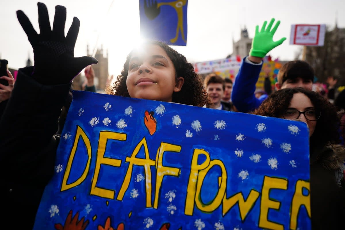 Pupils from Heathlands School for Deaf Children in St Albans take part in a rally outside the Houses of Parliament, Westminster, as the British Sign Language Private Members' Bill, introduced by Rosie Cooper MP, reaches its second reading in January 2022 (PA)