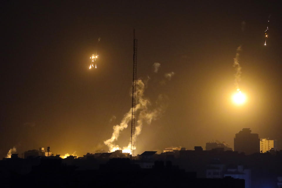 FILE - Israeli forces' flares light up the night sky in northern Gaza Strip, Nov. 4, 2023. The White House says Israel has agreed to put in place four-hour daily humanitarian pauses in its assault on Hamas in northern Gaza.(AP Photo/Abed Khaled, File)