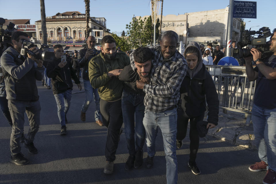 Undercover Israeli police detain a Palestinian man following minor clashes in Jerusalem's Old City, Wednesday, April 20, 2022. Police prevented hundreds of ultra-nationalist Israelis from marching around predominantly Palestinian areas of Jerusalem's Old City. The event planned for Wednesday was similar to one that served as one of the triggers of last year's Israel-Gaza war. (AP Photo/Mahmoud Illean)