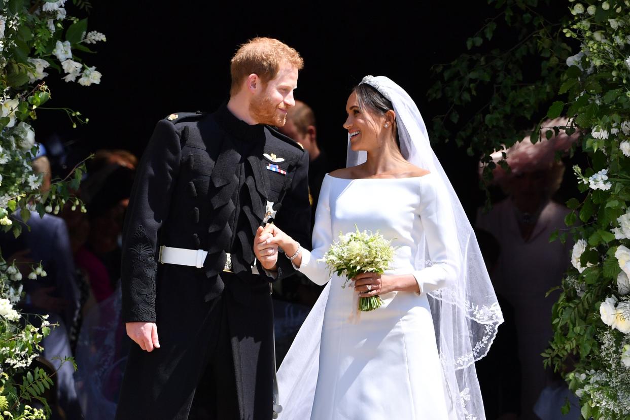 Prince Harry and Meghan Markle emerge from the West Door of St George's Chapel, Windsor Castle, in Windsor, on May 19, 2018 after their wedding ceremony. [Photo: Getty]