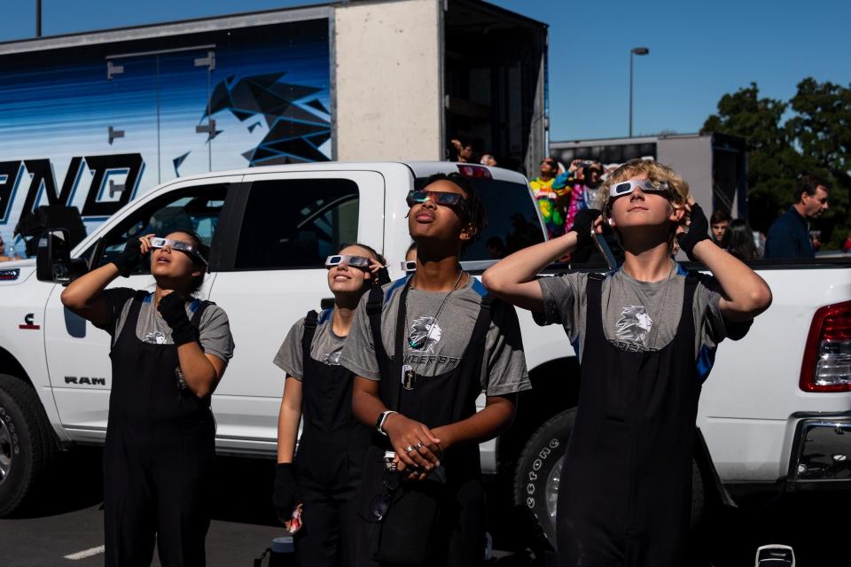 Members of the Leander High Band safely view October's annular solar eclipse. Some Central Texas school districts will close for the April 8 total solar eclipse.