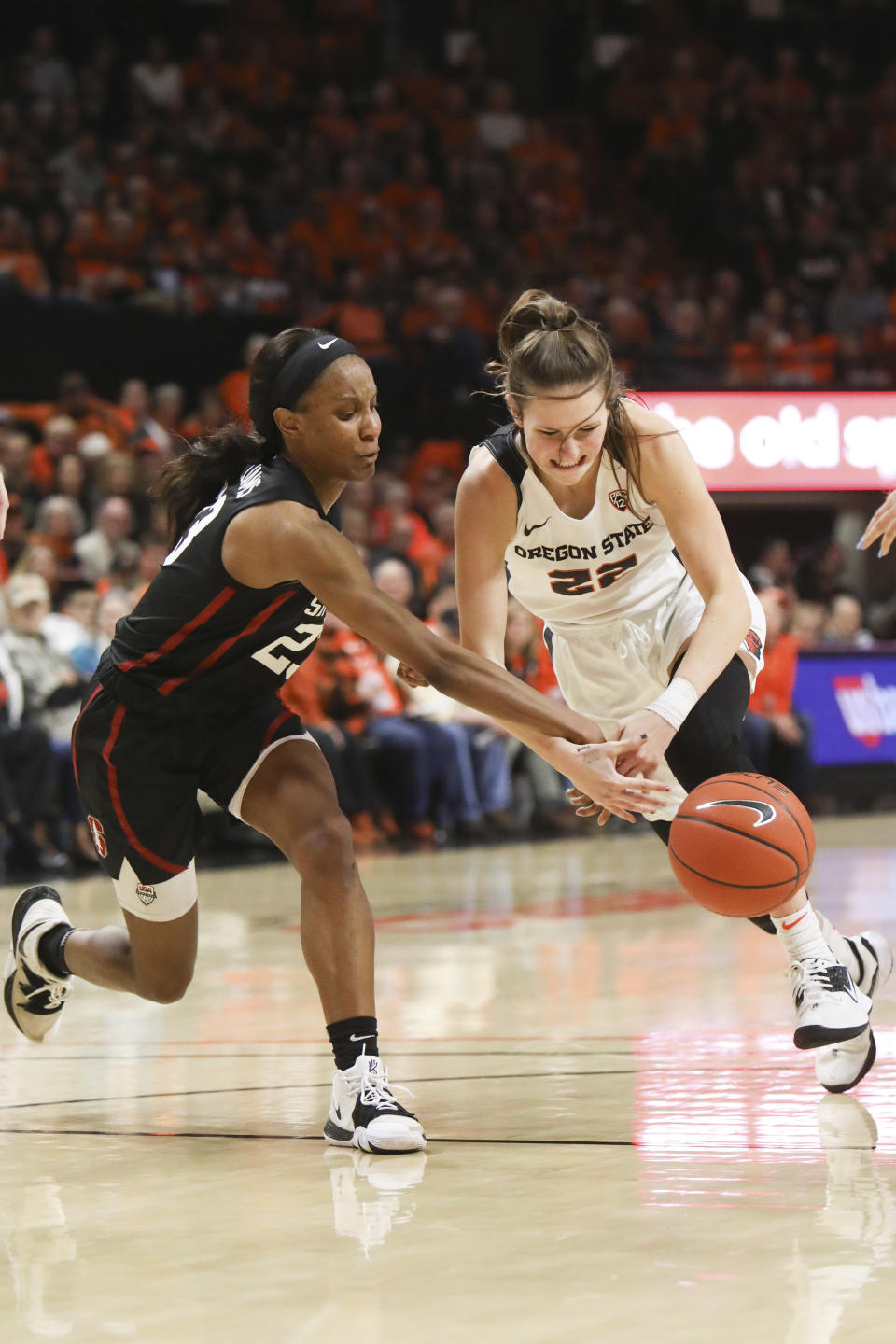Stanford's Kiana Williams (23) swats the ball away from Oregon State's Kat Tudor (22) during the first half of an NCAA college basketball game against Oregon State/Stanford in Corvallis, Ore., Sunday, Jan. 19, 2020. (AP Photo/Amanda Loman)