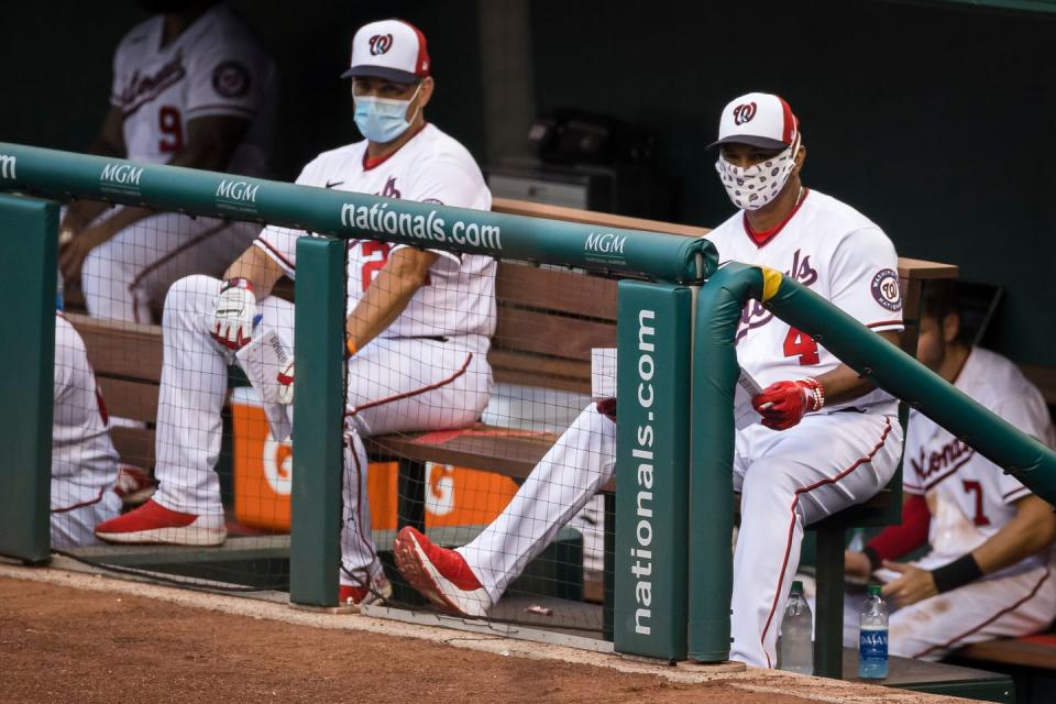 <p>Manager Dave Martinez #4 and bench coach Tim Bogar #24 of the Washington Nationals look on from the dugout during the second inning of the game against the Baltimore Orioles at Nationals Park on July 21 in Washington, DC.</p>