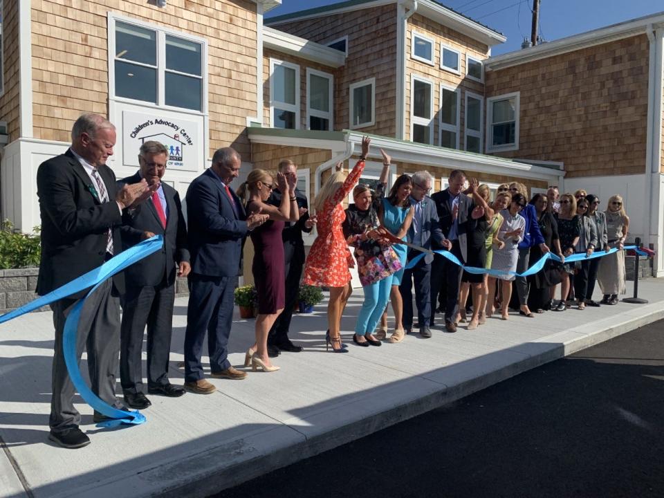 Leaders of the Children’s Advocacy Center of Bristol County, local officials and donors cut a ribbon to celebrate the opening of the organization's newly renovated building in Fall River on Sept. 16, 2022.