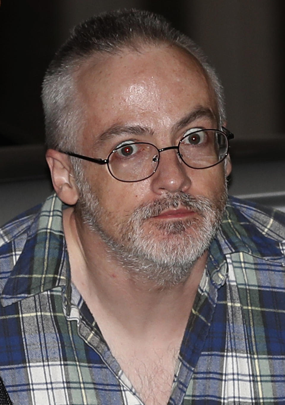 FILE - In this Aug. 19, 2017 file photo, Wyndham Lathem arrives at a police station as he is escorted by Chicago police in Chicago. Andrew Warren, a British man accused in the fatal stabbing of a hair stylist in Chicago, agreed Monday, July 22, 2019 to plead guilty and testify against his co-defendant, Wyndham Lathem, in the killing of a former Northwestern University professor in exchange for a 45-year-prison sentence. (AP Photo/Jim Young, Pool File)