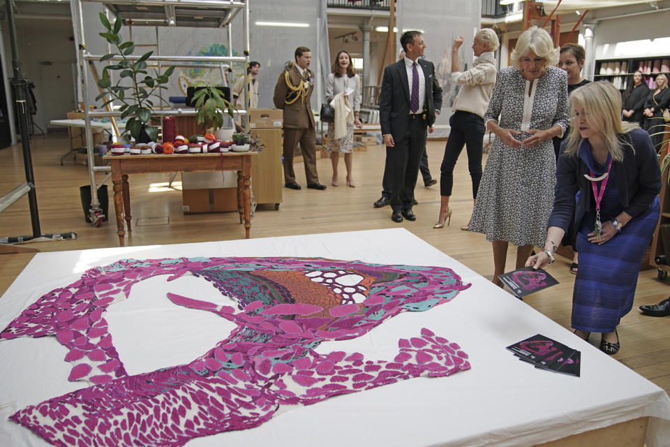 Britain's Queen Camilla, second from right, visits Dovecot studios to meet weavers, staff and local crafts people, as part of the first Holyrood Week since her husband, King Charles III's, coronation, in Edinburgh, Scotland, Wednesday, July 5, 2023. Two months after the lavish coronation of King Charles III at Westminster Abbey in London, Scotland is set to host its own event to mark the new monarch’s accession to the throne. (Peter Byrne/Pool Photo via AP)