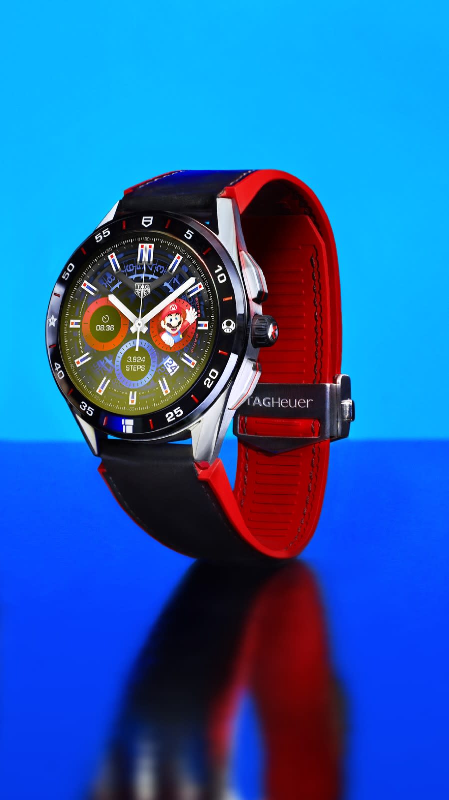 <p>Front view of the Tag Heuer Connected Limited Edition Super Mario with a black-and-red strap against a blue background.</p>
