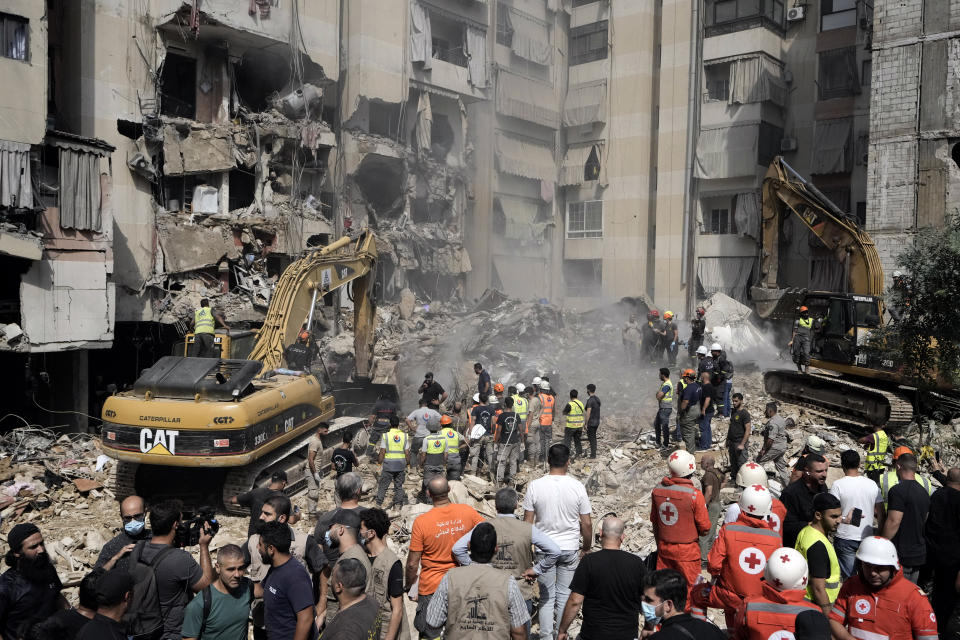 Emergency workers use excavators to clear the rubble at the site of Friday's Israeli strike in Beirut's southern suburbs, Saturday, Sept. 21, 2024. (AP Photo/Bilal Hussein)