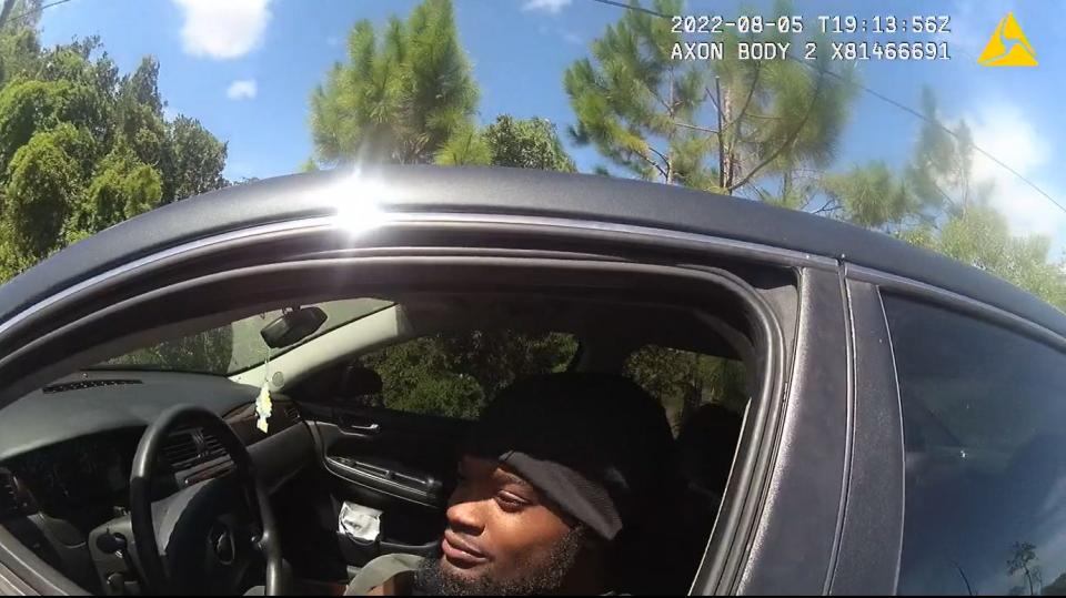 In a screenshot from a sheriff's body camera video, Darius Jermaine Ned Thomas Jr., 22, of Jacksonville, Florida, leans out his driver's window Aug. 5, 2022, to accept a $114 ticket from Jacksonville Sheriff's Office deputy M.L. Albert for playing his music too loudly. Black drivers, like Thomas, are nearly three times as likely as white ones to be ticketed under the law, according to a new investigation by the University of Florida College of Journalism and Communications.