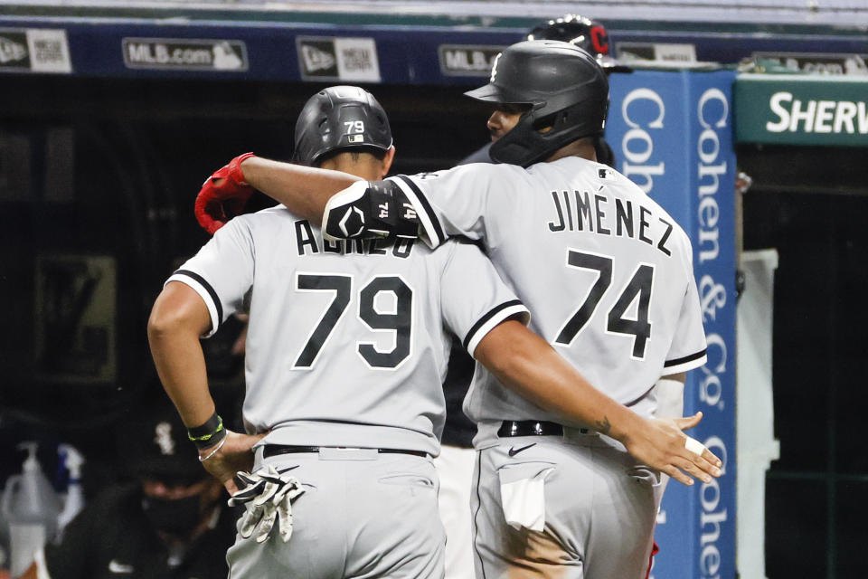 Chicago White Sox's Eloy Jimenez (74) celebrates with Jose Abreu (79) after hitting a two-run home run off Cleveland Indians pitcher Aaron Civale during the fifth inning of a baseball game, Monday, Sept. 21, 2020, in Cleveland. (AP Photo/Ron Schwane)