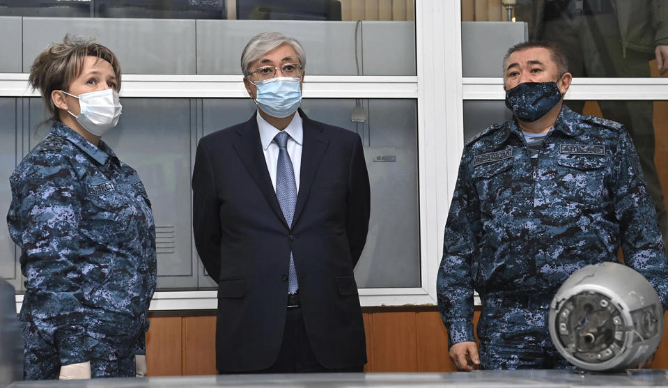 In this handout photo released by Kazakhstan's Presidential Press Service, Kazakhstan's President Kassym-Jomart Tokayev, center, visits the Center for Operational Management of the Police Department in Almaty, Kazakhstan, Wednesday, Jan. 12, 2022. Kazakh authorities said Wednesday they detained 1,678 more people in the past 24 hours over their alleged participation in the violent unrest that rocked the former Soviet nation last week, the worst since Kazakhstan gained independence three decades ago. (Kazakhstan's Presidential Press Service via AP)