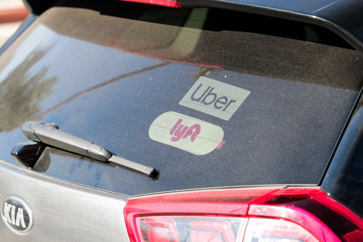 Uber and Lyft decals are shown on a vehicle at Palm Springs International Airport on Wednesday, Jan. 22, 2020 in Palm Springs, Calif.