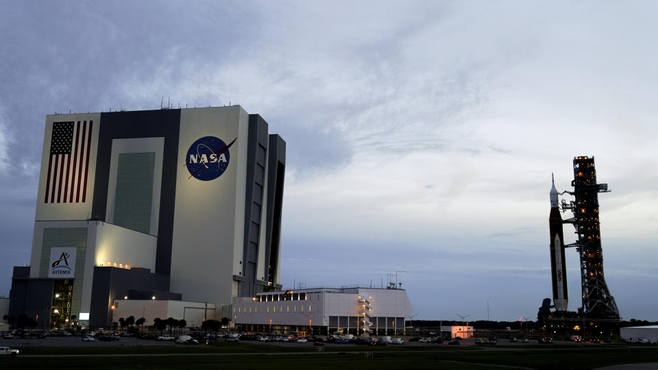 The NASA moon rocket slated for the Artemis mission to the moon rolls back to the Vehicle Assembly Building at the Kennedy Space Center Tuesday, Sept. 27, 2022, in Cape Canaveral, Fla. The launch of the rocket was postponed due to the impending arrival of Hurricane Ian. (AP Photo/John Raoux)