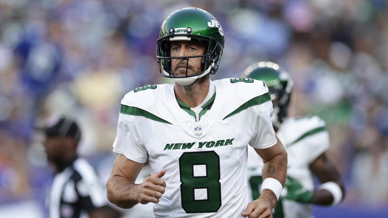 New York Jets quarterback Aaron Rodgers (8) runs the field during the first half of an NFL preseason football game against the New York Giants, Saturday, Aug. 26, 2023, in East Rutherford, N.J. (AP Photo/Adam Hunger)