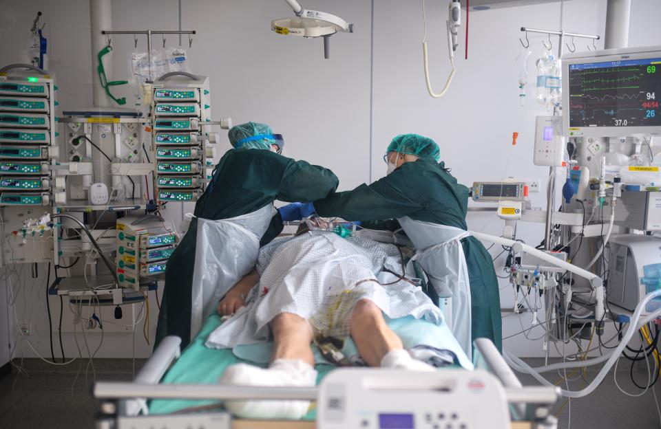 Nurses look after a COVID-19 patient at the Covid-19 intensive care unit of the university hospital (Universitaetsklinikum) in Essen, western Germany, on October 28, 2020. - German Chancellor Angela Merkel is seeking drastic new curbs, including fresh shutdowns hitting leisure, sports and the food and drink sectors, as she holds crisis talks with Germany's regional leaders to halt surging coronavirus infections and save the Christmas holiday season. (Photo by Ina FASSBENDER / AFP) (Photo by INA FASSBENDER/AFP via Getty Images)