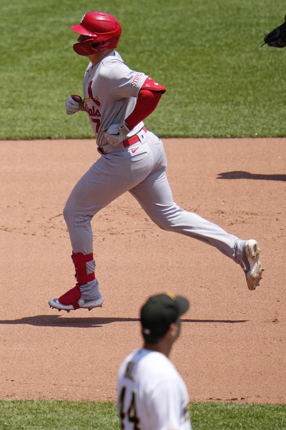 St. Louis Cardinals' Andrew Knizner, top, rounds the bases after hitting a solo home run off Pittsburgh Pirates starting pitcher Rich Hill, bottom, during the seventh inning of a baseball game in Pittsburgh, Sunday, June 4, 2023. (AP Photo/Gene J. Puskar)