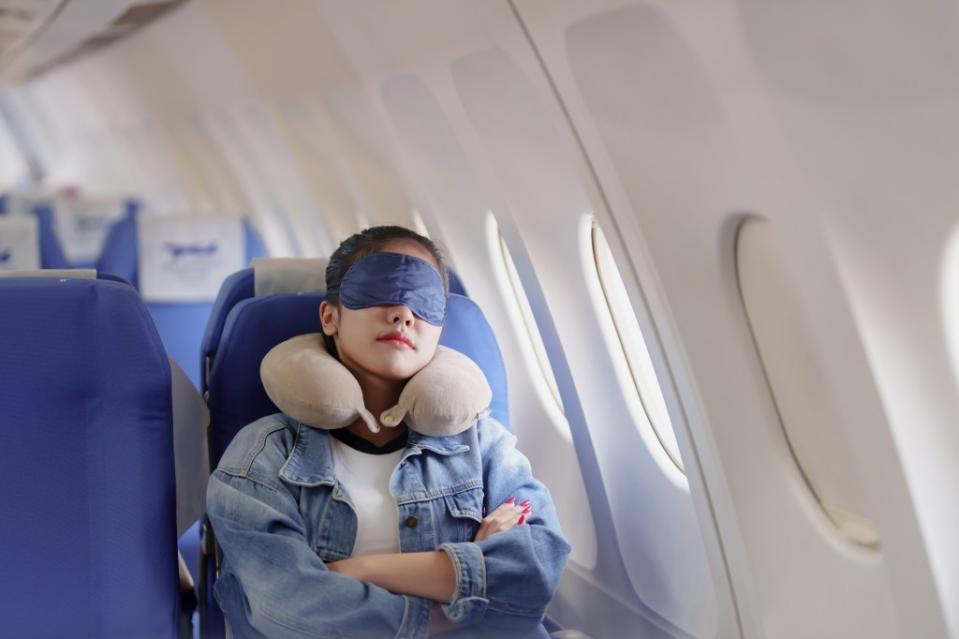 The best plane seat for sleep is the window seat, according to experts. mojo_cp – stock.adobe.com